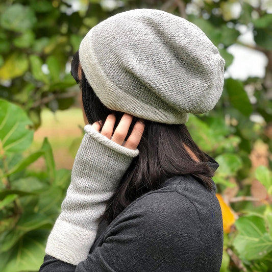 Model in the gray alpaca hat worn slouched, with matching light gray fingerless gloves
