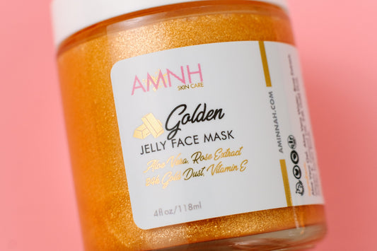 Jar of gold jelly face mask with the AMNH label facing forward on pink.