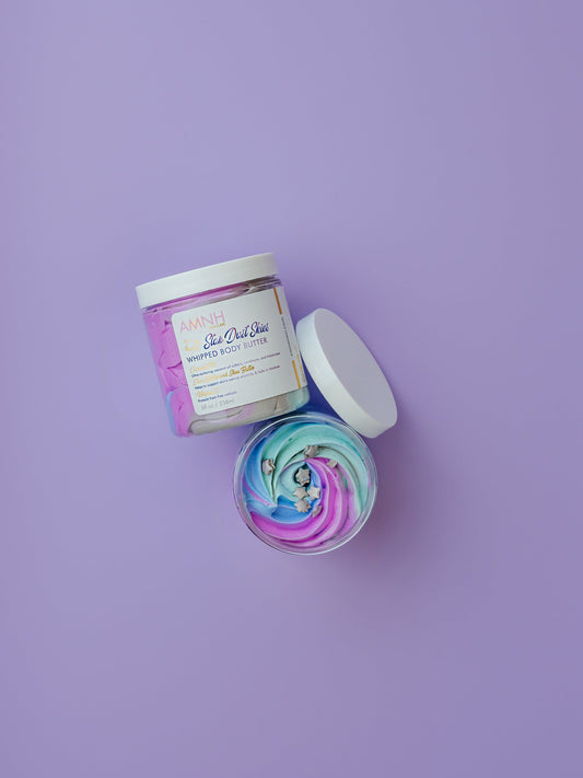 Open jar with a purple whipped swirl and the lid beside it on purple.