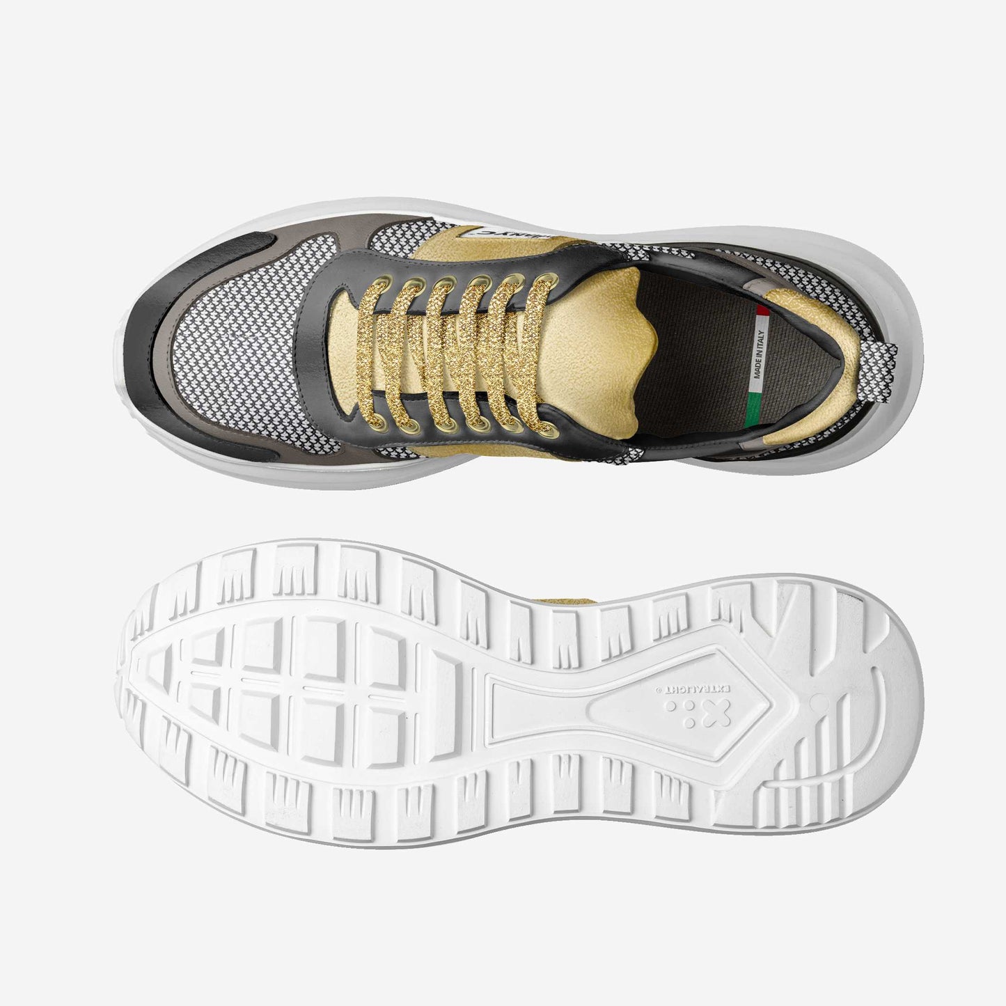 Close view of the gold panel and BYMANYC badge on a vegan sport sneaker with a white foamed sole.