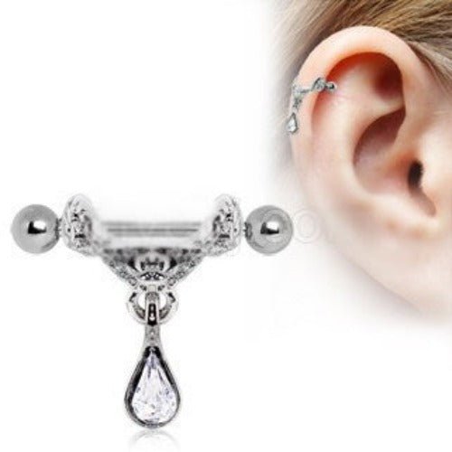 Tiara cartilage cuff with a floral shield, ball ends and a clear teardrop dangle, with an inset worn on the upper ear