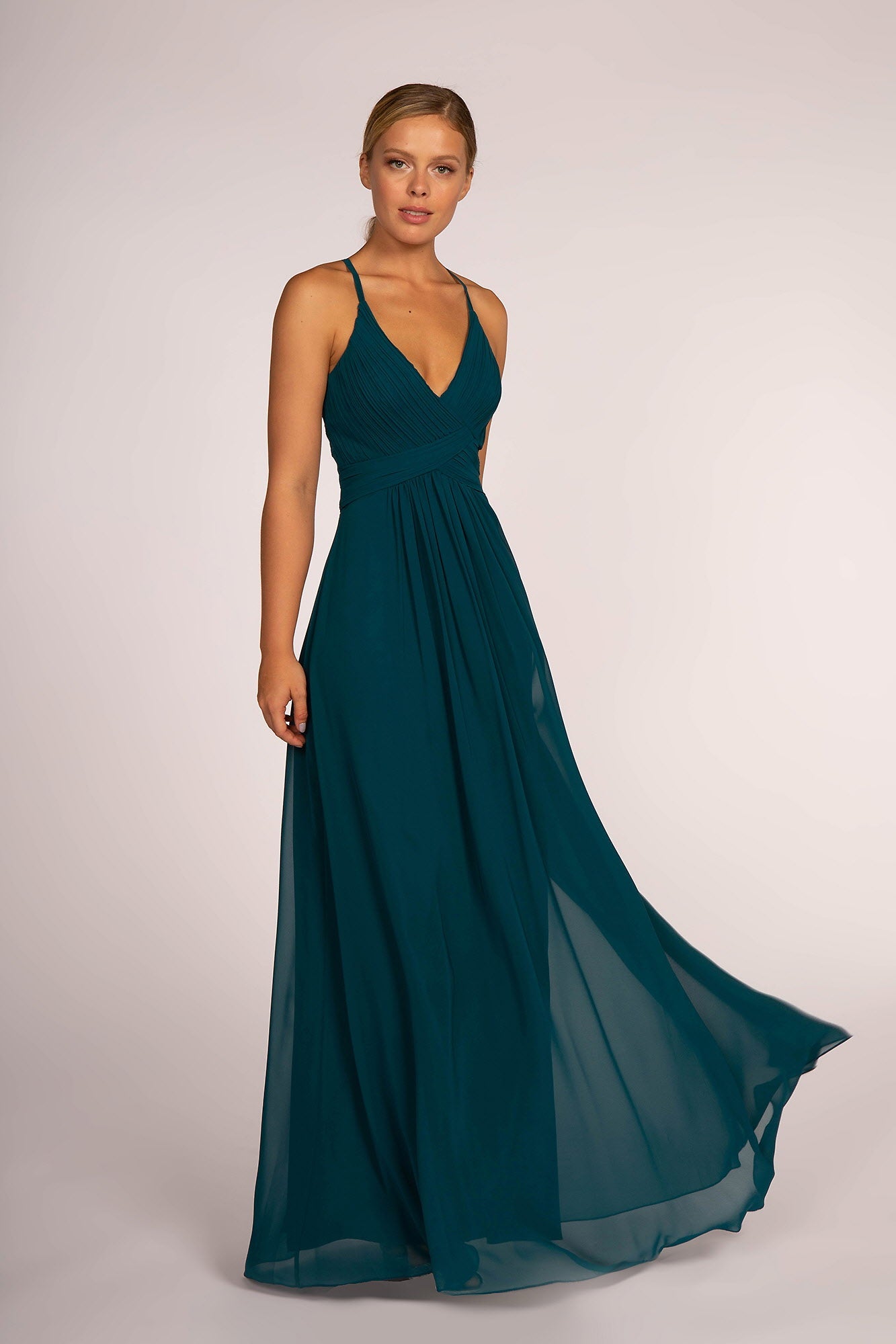 Teal chiffon gown with a ruched V-neck bodice and spaghetti straps.