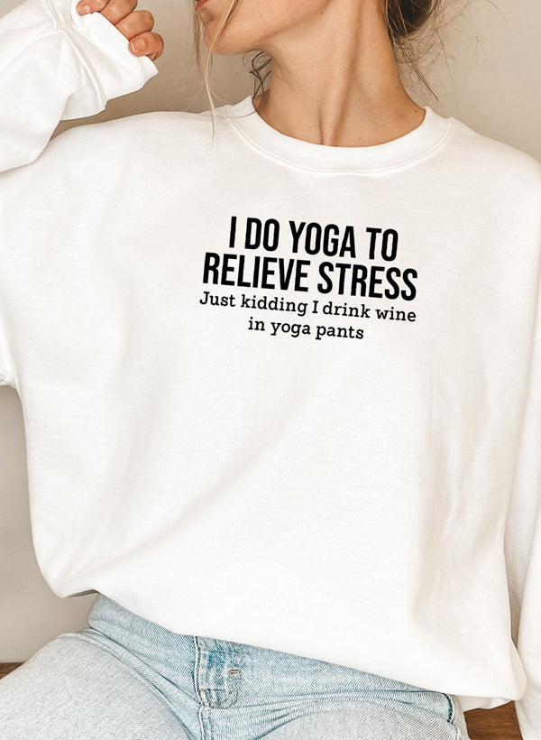 White cotton fleece crewneck, yoga slogan printed across the chest.