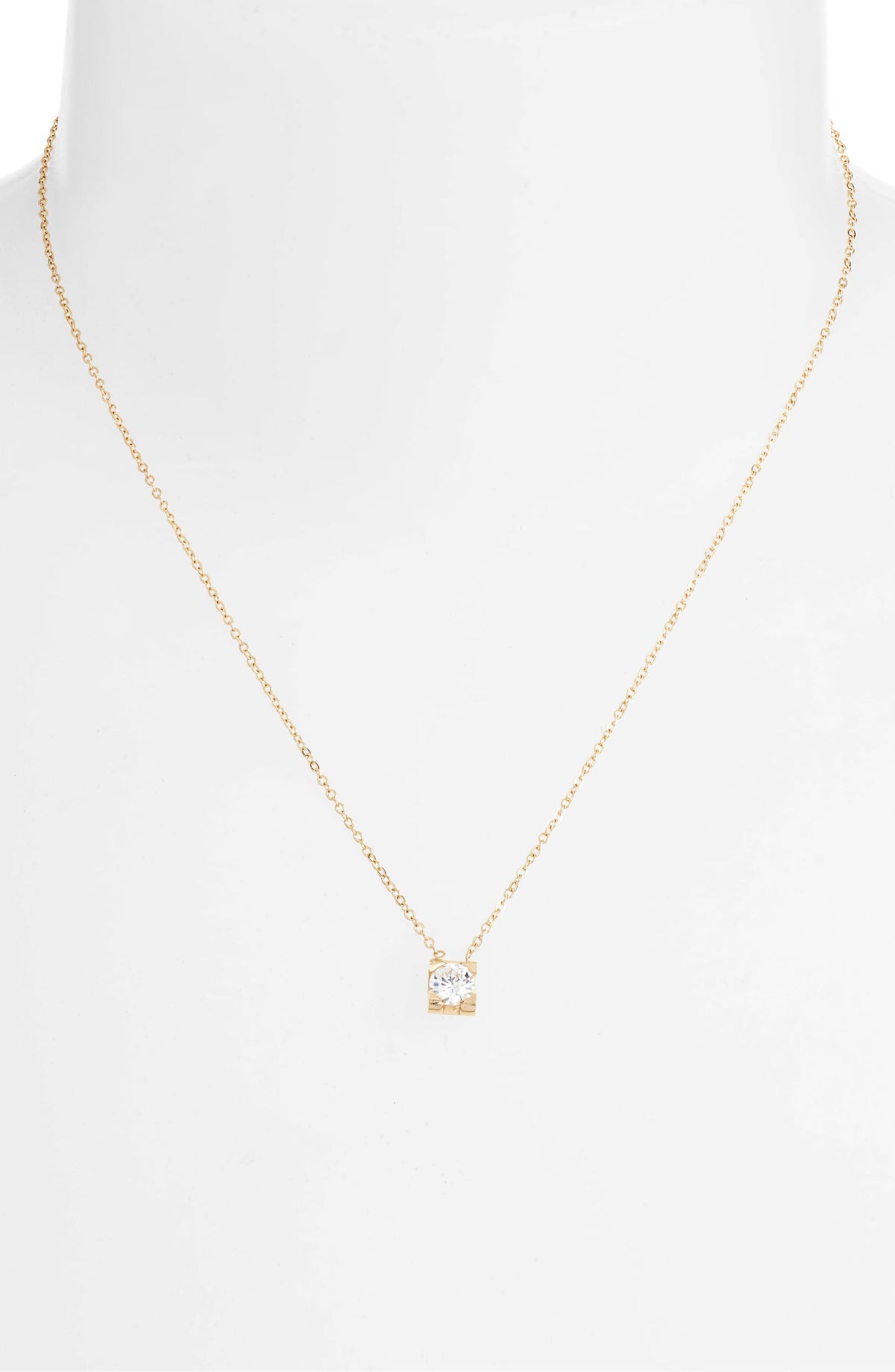 CZ solitaire necklace on a white bust form, the small square pendant resting below the collarbone