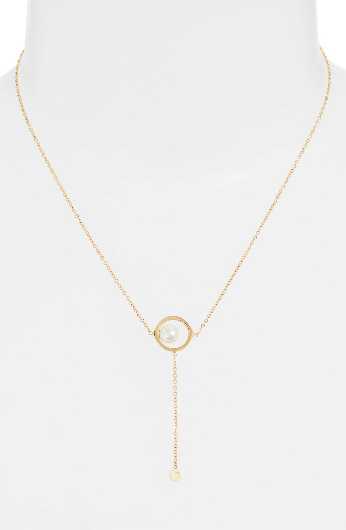 Pearl drop necklace on a white bust form, the pearl frame at the chest and the fine drop below it