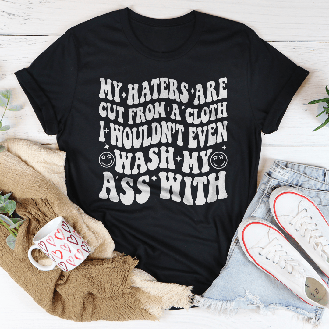 Black heather cotton tee with bold graphic "My haters are cut from a cloth" design on the front.