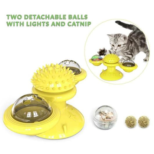 Yellow suction cup windmill cat toy with a spiky center and two clear dome balls, plus a light ball and two catnip balls