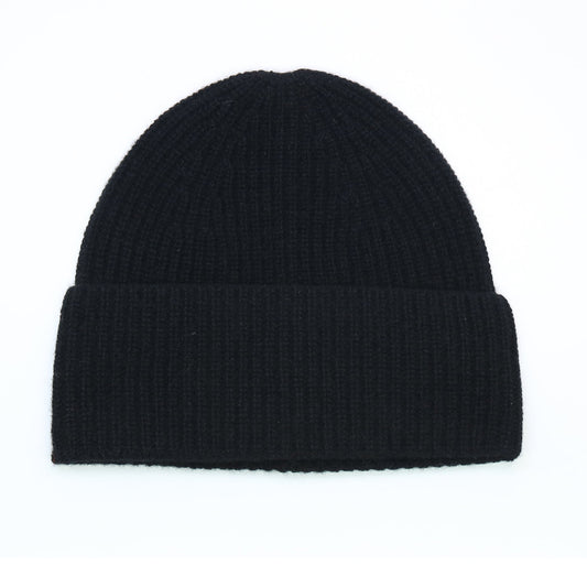 Black ribbed cashmere hat laid flat, cuff turned back