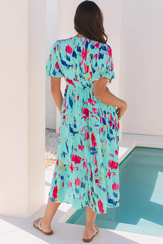 Back view of the aqua abstract print tiered midi dress