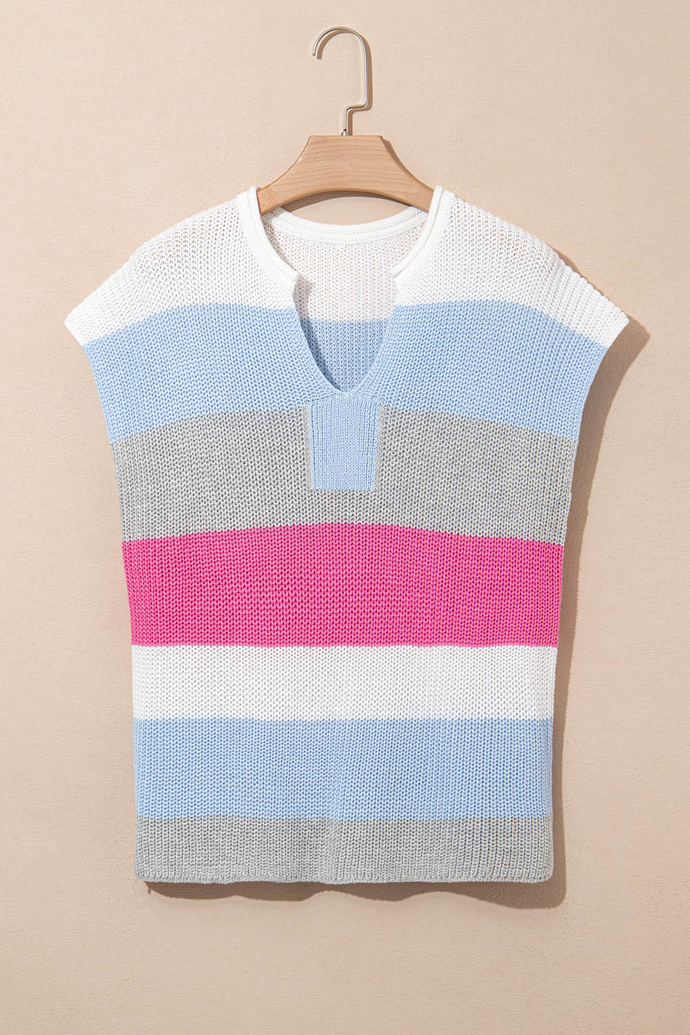 Light blue, gray and pink striped knit top on a hanger