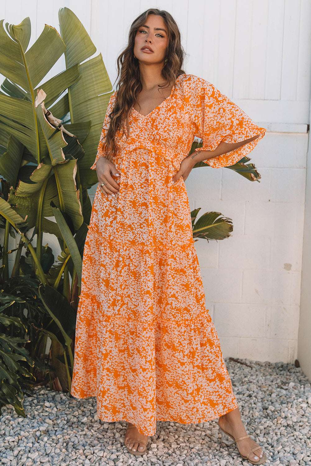 Orange floral tiered maxi dress, model with a hand on her hip