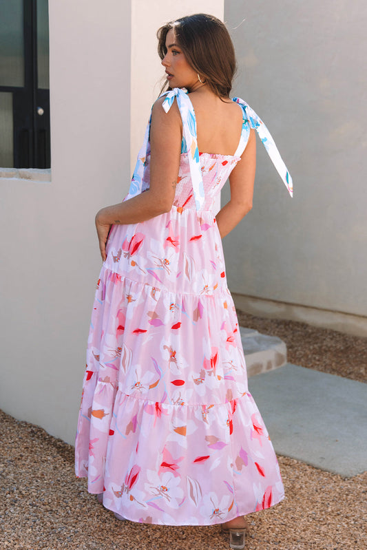 Back view of the pink floral maxi dress showing the bow-tied shoulder straps