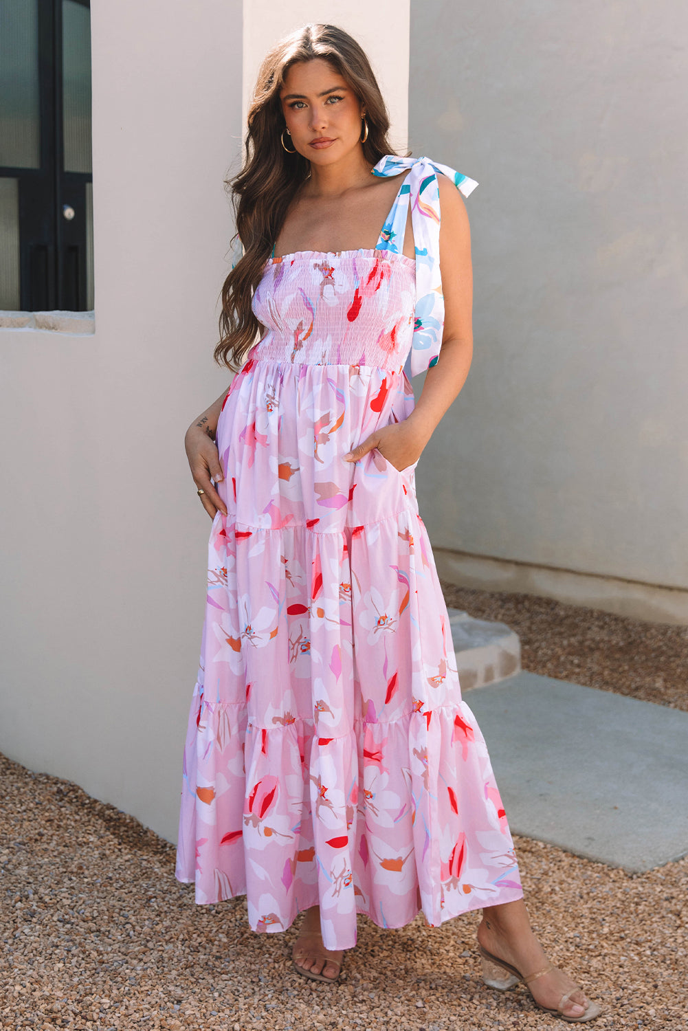 Side view of the pink floral tie strap maxi dress and its tiered skirt
