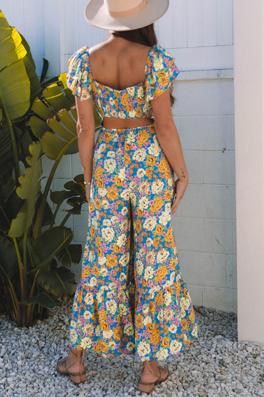 Back of the yellow floral jumpsuit showing the open cut-out
