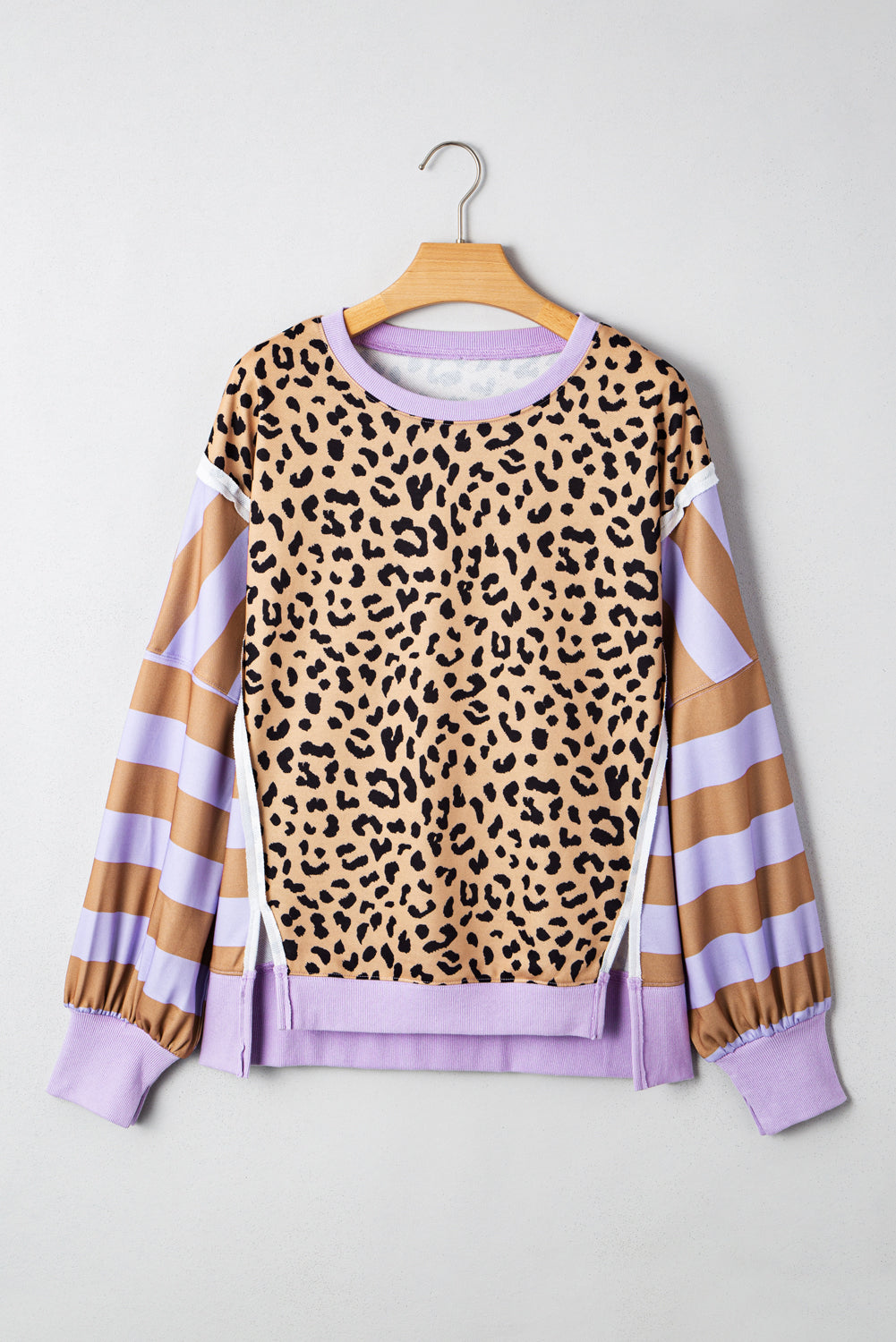 Leopard sweatshirt with striped sleeves on a hanger