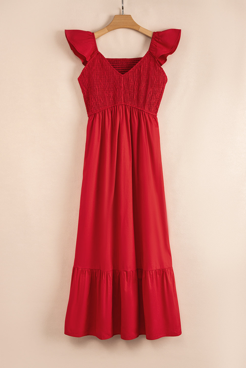 Red smocked bodice flutter sleeve maxi dress on a hanger