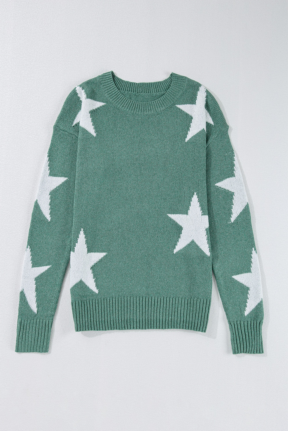 Green crewneck sweater with white stars laid flat