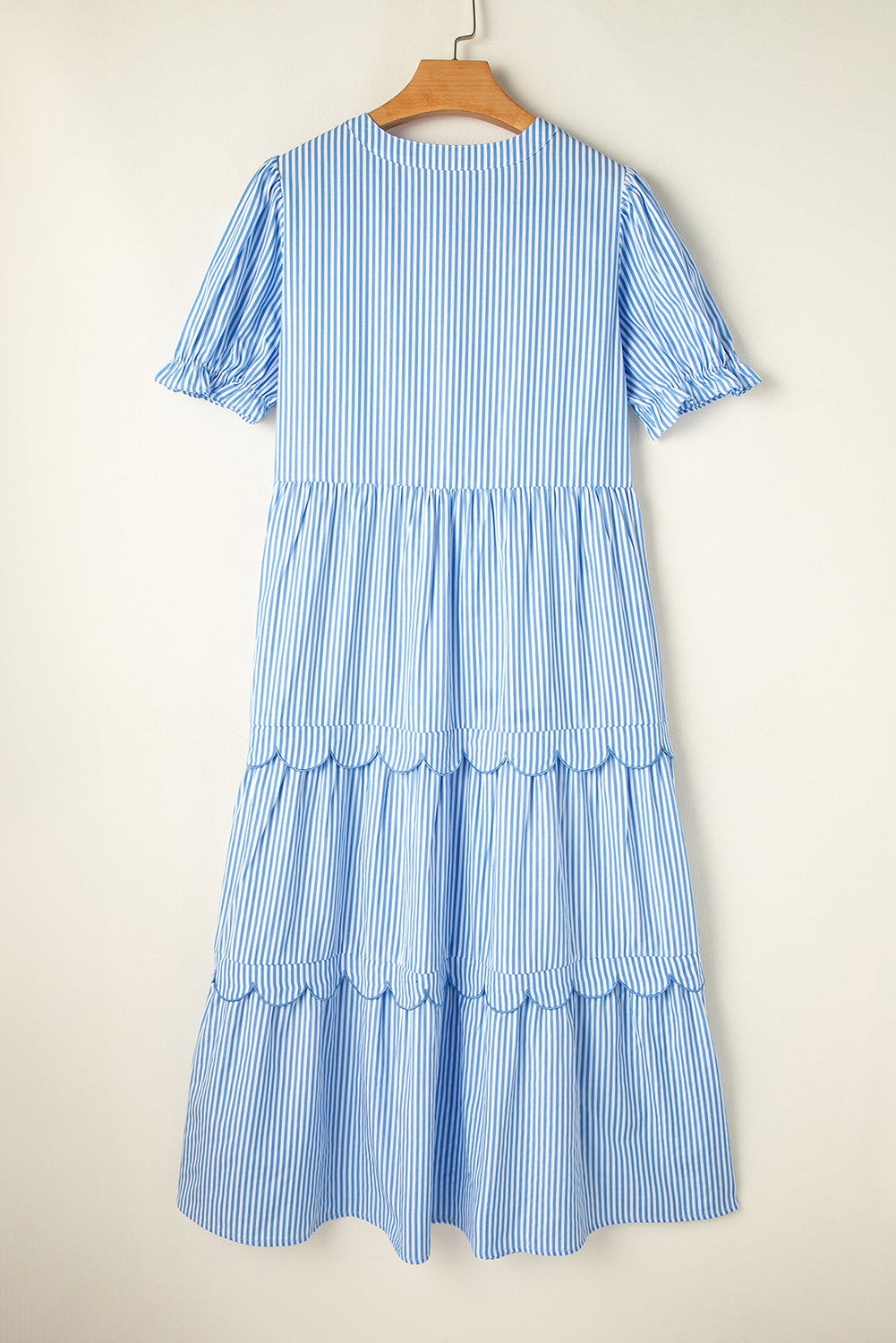 Light blue striped midi dress on a hanger, back view