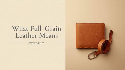 What Full-Grain Leather Means. Overhead flat-lay of a tan full-grain leather bifold wallet and a coiled tan leather belt on cream