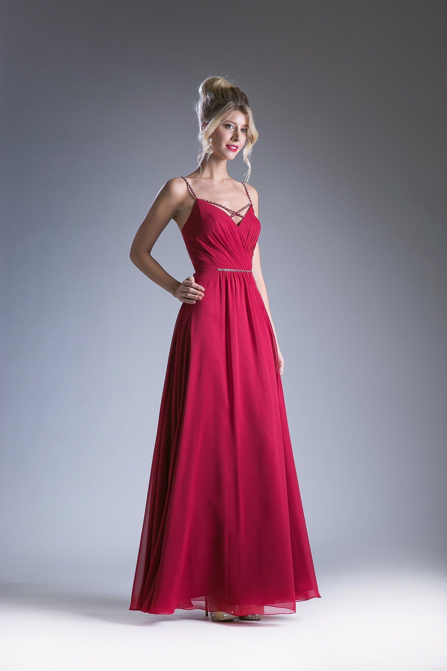 Burgundy V-neck evening gown with spaghetti straps and a beaded waistband.
