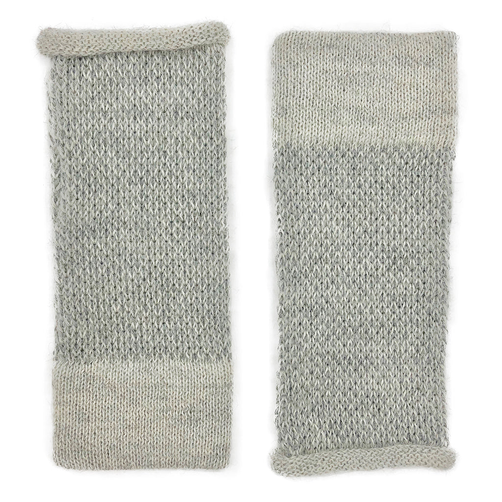 Pair of gray two-tone alpaca fingerless gloves laid flat, speckled knit with a solid pale gray band at the cuff