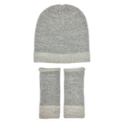 Gray two-tone alpaca beanie with a pale brim above matching fingerless gloves, laid flat on white