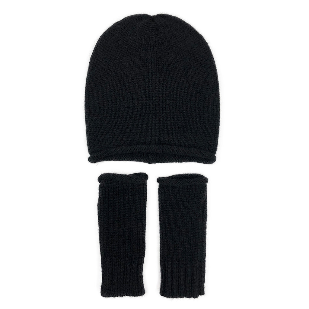Black slouchy beanie above a pair of matching black fingerless gloves, laid flat on white