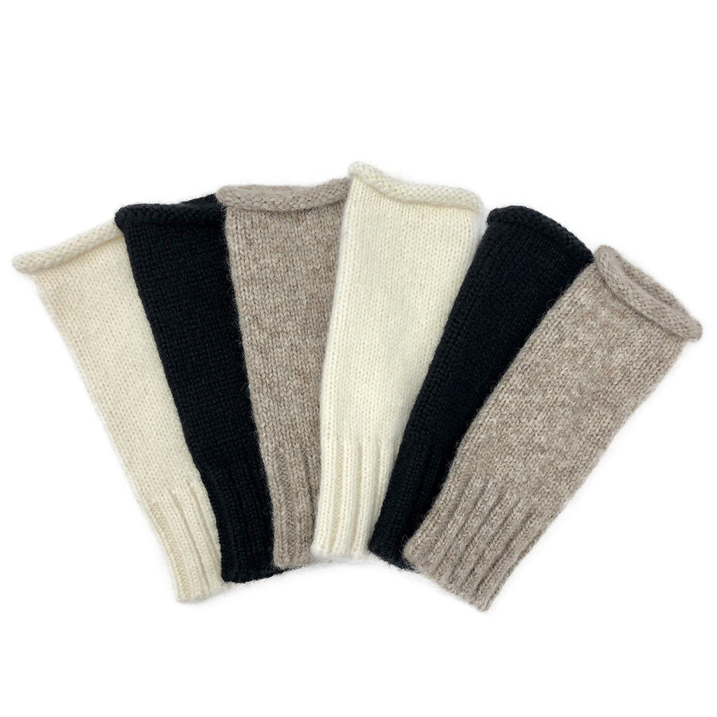 Six knit fingerless gloves fanned out in cream, black and taupe