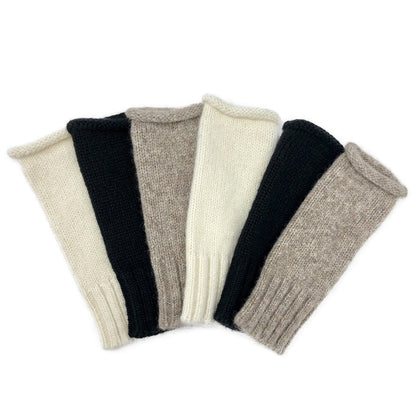 Six knit fingerless gloves fanned out in cream, black and taupe
