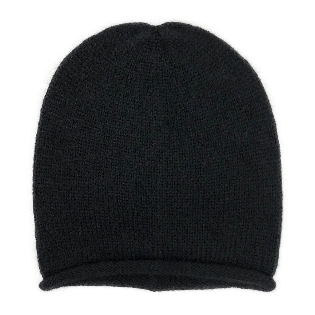 Black knit beanie laid flat from the front with its rolled brim