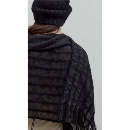 Back view of the black alpaca beanie with a black striped scarf over the shoulders