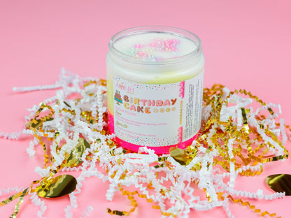 Scrub jar upright in paper shred with gold confetti pieces around it.