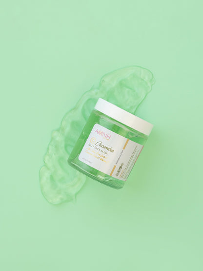 Blob of green jelly mask resting beside the closed jar on green.