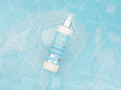 Single cleanser bottle lying on a textured blue surface.