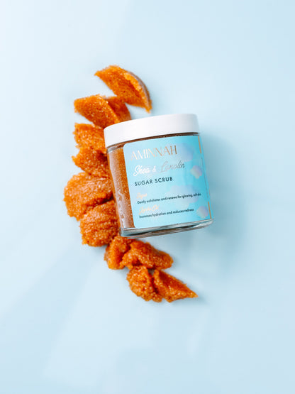 Jar with brown sugar scrub spilling out in a swirl on blue.