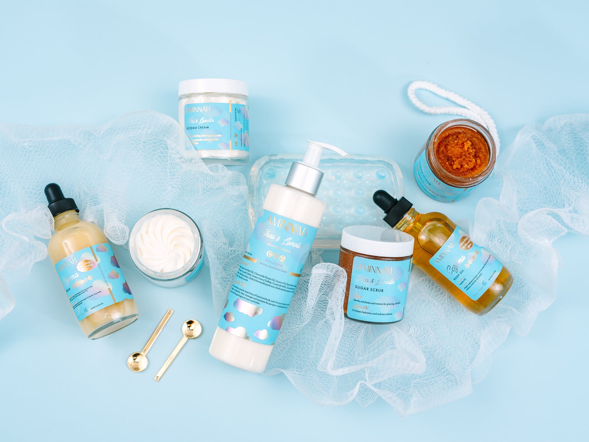 Jars, a dropper bottle and a mesh puff arranged together on blue.