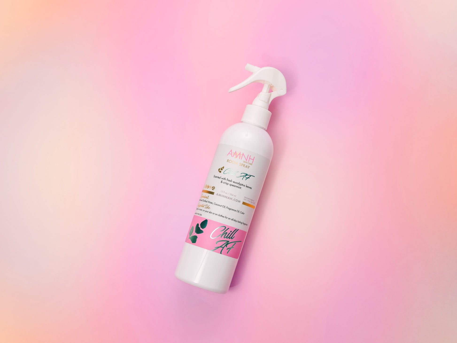 Single room spray bottle standing on a pale pink gradient.