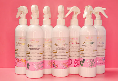 Row of AMNH room spray bottles standing together on pink.