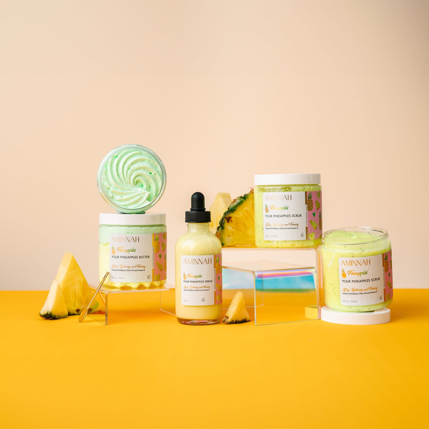 Three Fineapples products standing together with a whole pineapple behind them.