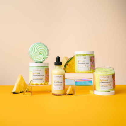 Three Fineapples products standing together with a whole pineapple behind them.