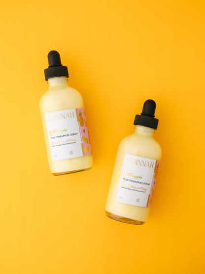 Two serum bottles standing side by side on a yellow background.