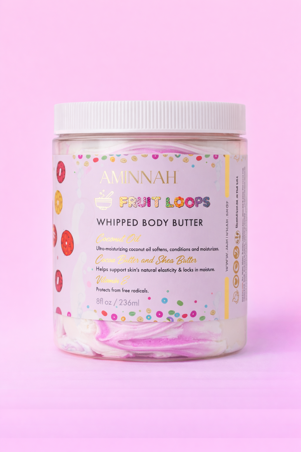 Jar of Frut Loops whipped body butter with the label facing forward on pale pink.