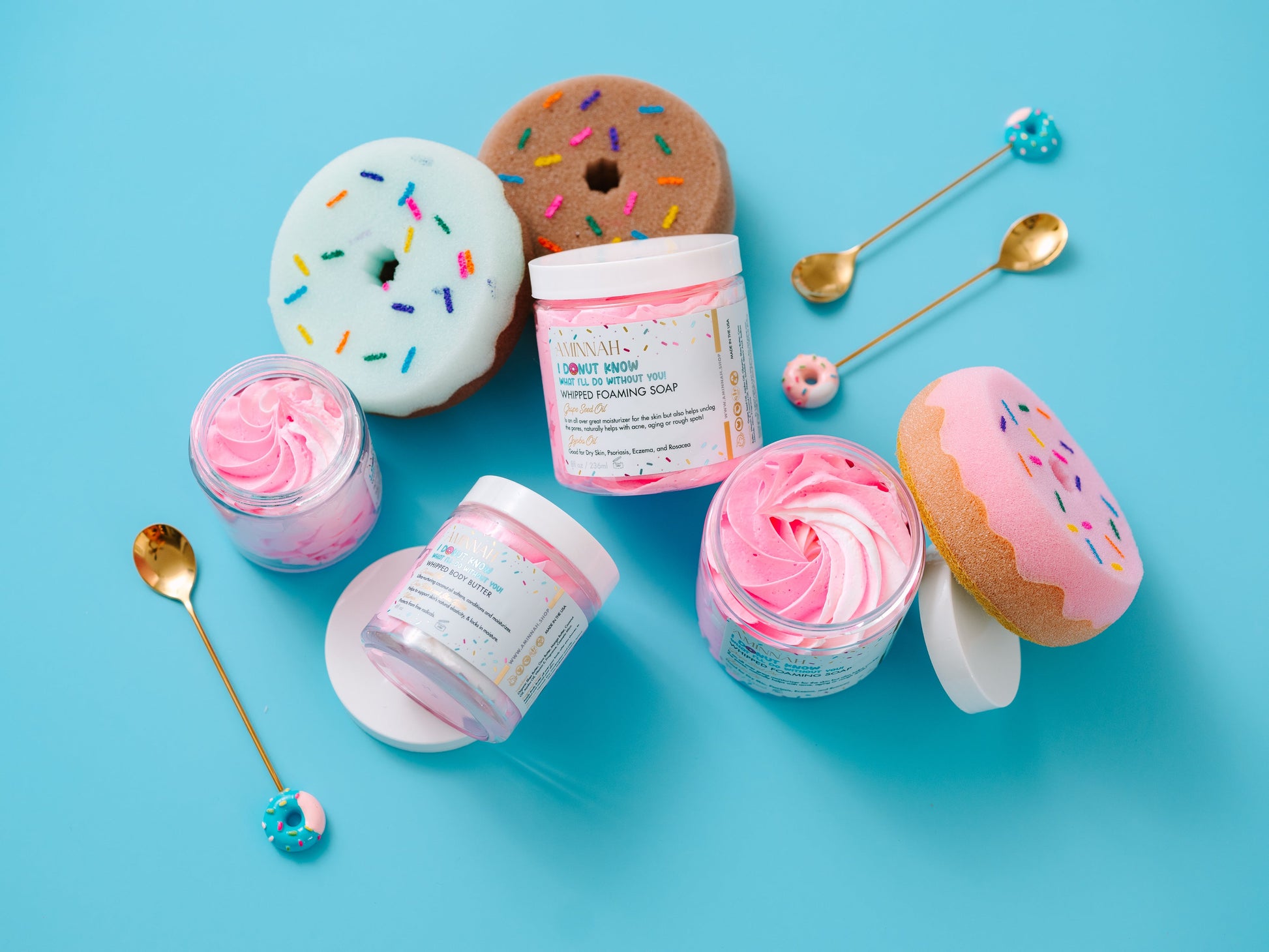 Flat lay of jars, a gold spoon and donut props on blue.