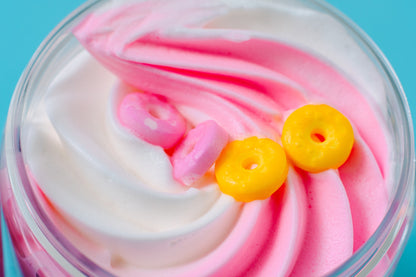 Overhead view of the pink and white whipped swirl with a cereal loop on top.
