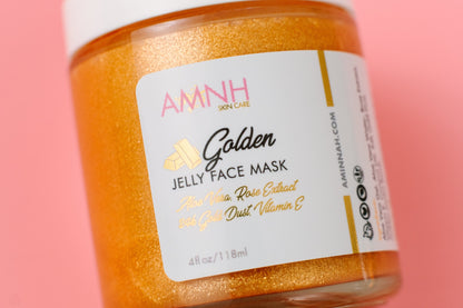 Jar of gold jelly face mask with the AMNH label facing forward on pink.