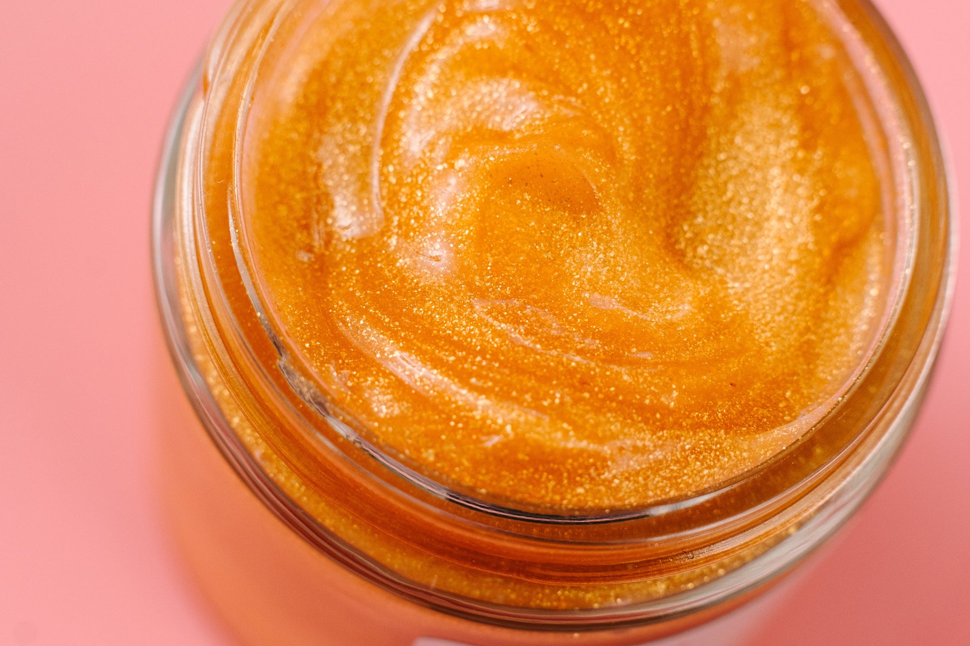 Overhead view of the open jar filled with shimmering gold jelly.