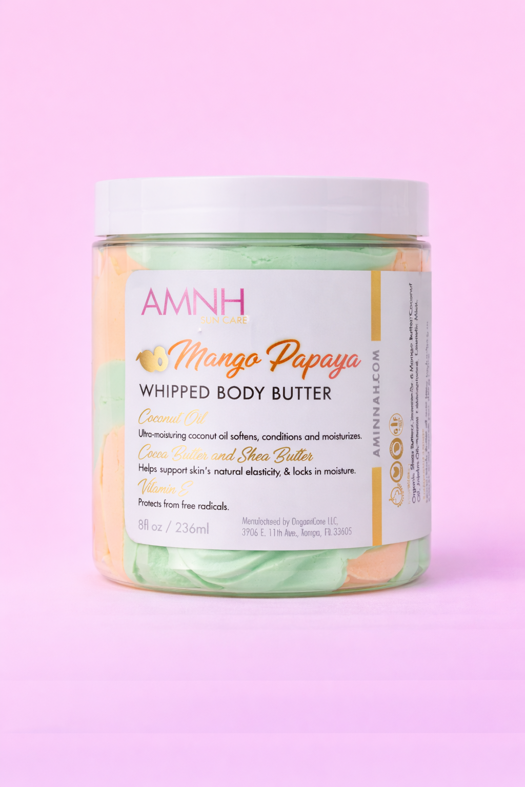 Jar of Mango Papaya body butter with the label facing forward on pale pink.