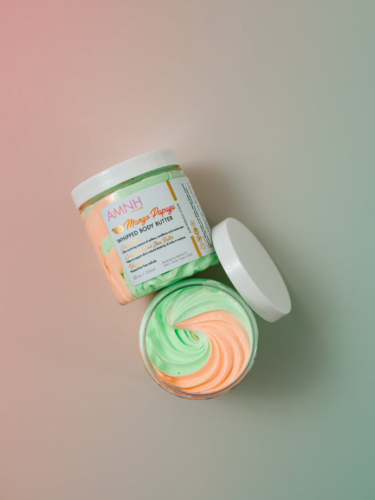 Open jar showing a green and orange whipped swirl with the lid beside it.