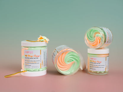 Two jars of whipped butter side by side on a pink and mint background.