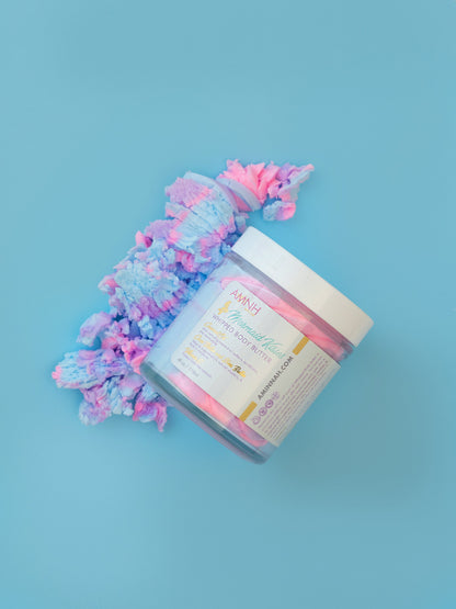 Open jar with a pink and blue whipped swirl on a blue background.